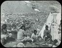 Image of Four Eskimos [Inuit] Sitting Near Tupik
